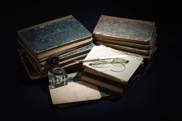 istock old books, papers, ink pen and inkpot on black background 901710300