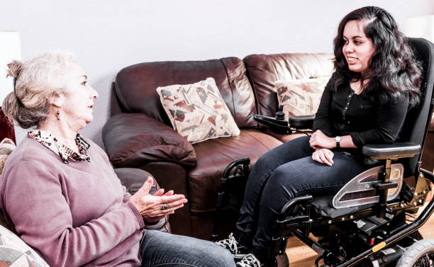 istock Senior chatting with disabled girl 901713924
