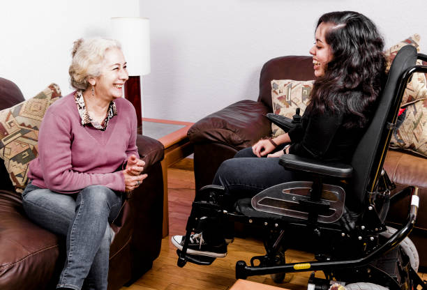 istock Senior chatting with disabled girl 901714214