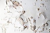 Blown plaster. Damp salt damaged wall surface in need of repair.