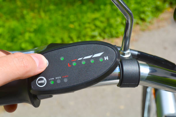 istock Turning on electric bike, E-bike or bicycle. Pressing a button on control board or controller to choose speed and power level. Unfiltered, with natural lighting 901729602