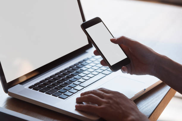 istock multitasking woman using tablet, laptop and smart phone, with blank screens, indoors on a table 901748110