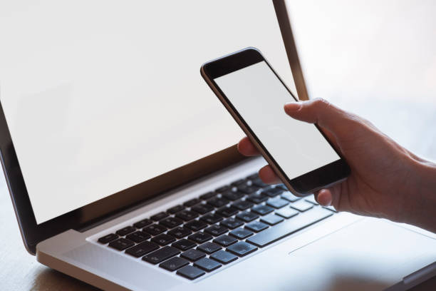 istock multitasking woman using tablet, laptop and smart phone, with blank screens, indoors on a table 901754392