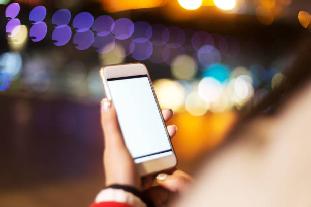 istock woman's hand with mobile phone on street 901761894