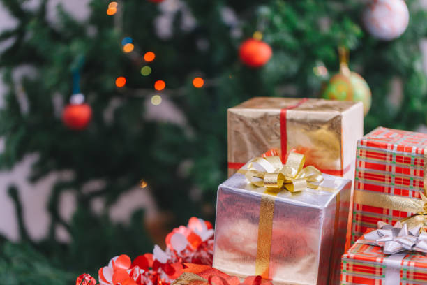istock Christmas gift box and Christmas decoration with Christmas tree at back side. Copy space for your text. 901762308