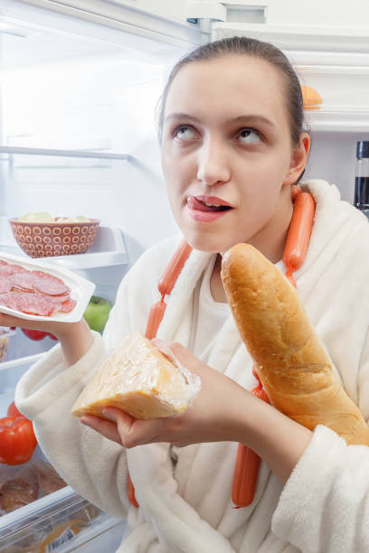 istock hungry woman eating 901779828
