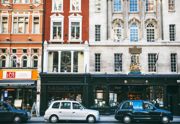 London, UK - December 28, 2015: People walking in SOHO of London,UK.Bars/restaurants can be seen in the background.