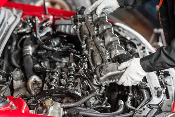 istock Repairing of modern diesel engine, workers hands and tool. Car mechanic looking at engine for analysis symptoms of car at maintenance repair service station 901785450