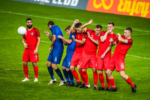 istock Players lined up defending from a free kick 901787544