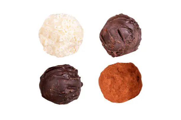 Detailed view of yummy tasty milky chocolate ball on hand, isolated on white background.