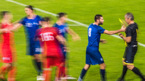 istock Referee showing yellow card on the field 901788414