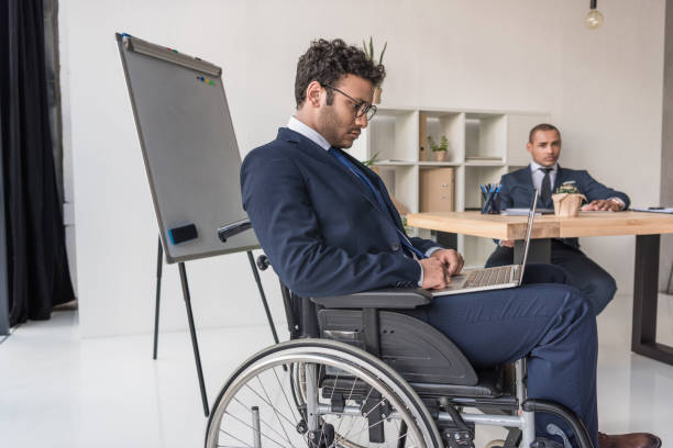 istock disabled african american businessman with laptop 901788632