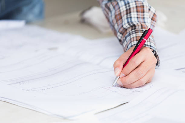 istock Management consulting with engineers working with blueprint and drawing on work table in for management business plan and construction site project. 901788758