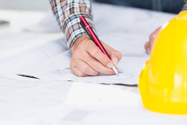 istock Management consulting with engineers working with blueprint and drawing on work table in for management business plan and construction site project. 901788766