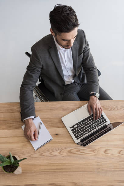 istock disabled businessman at workplace 901789398