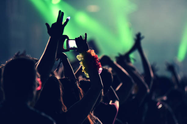 istock Crowd rocking during a concert with raised arms. 901789568