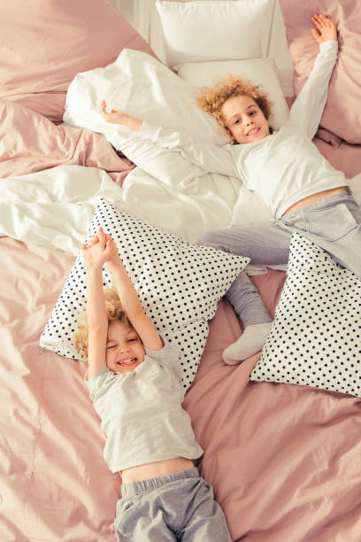 istock Brothers laying on the bed 901789874