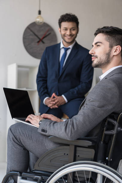 istock disabled businessman with laptop 901792196