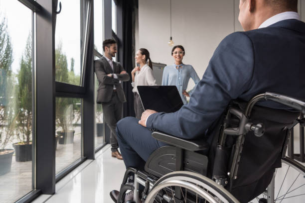 istock disabled businessman with laptop 901792292
