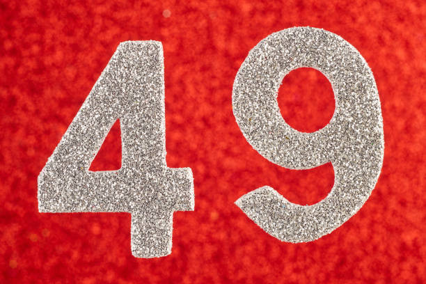 istock Number forty-nine silver color over a red background. Anniversary 901797206