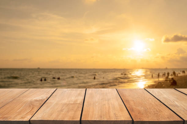 istock Empty wooden table and blurred  sunset beach background 901797400