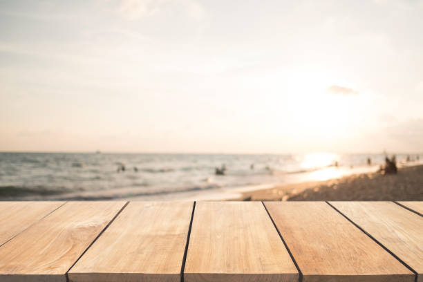 istock Empty wooden table and blurred  sunset beach background 901797408