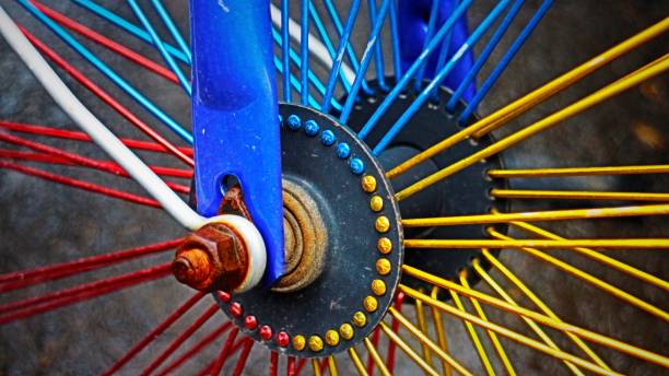 Bicycle wheel and spokes close-up in red, blue and yellow.