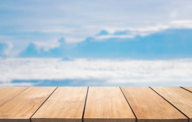 istock Empty wooden table against blur blue sky background, 901797890