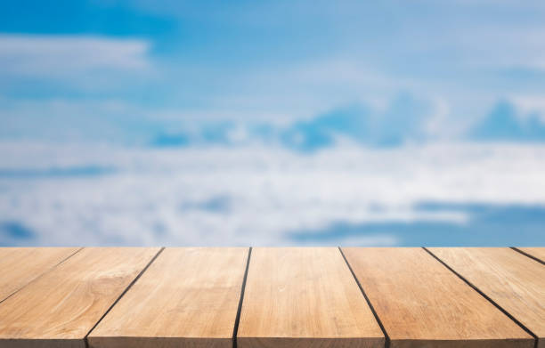 istock Empty wooden table against blur blue sky background, 901798040