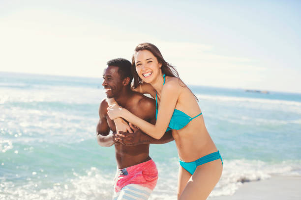 istock Cheerful couple walking at beach on sunny day 901805124