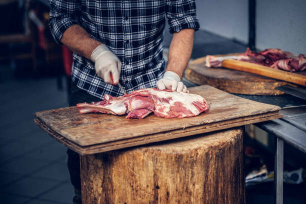 istock Bearded butcher cut fresh bacon meat. 901805278