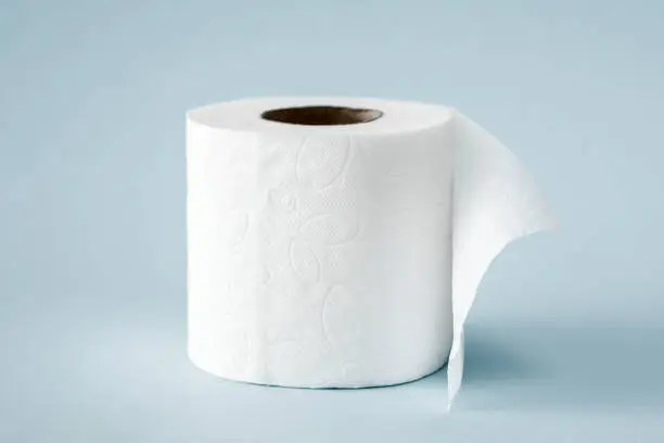 Photo of White roll toilet paper on the  light blue background