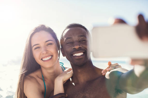 istock Happy couple taking selfie through smart phone 901806060