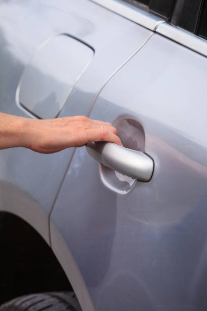 istock Human hand holding car door handle 901810210