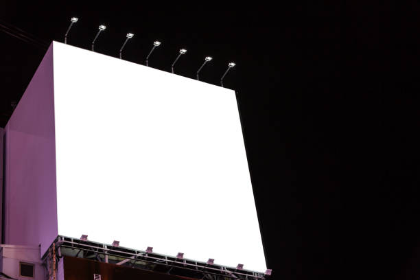 istock blank billboard on the building urban in the night - can advertisement for display or montage product or business 901810544