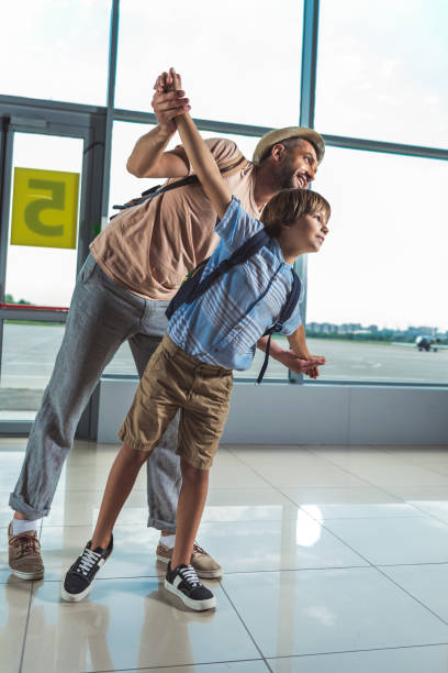 istock father and kid in airport 901813688