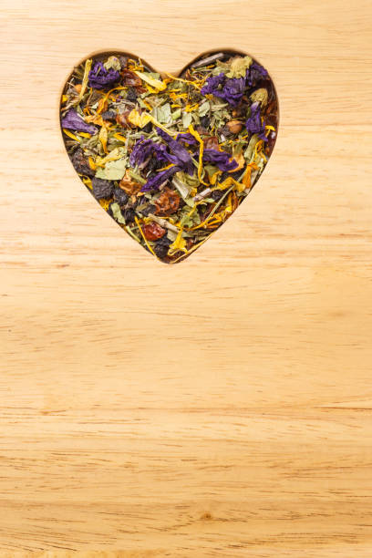 istock Dried herb leaves heart shaped on wooden surface 901813882