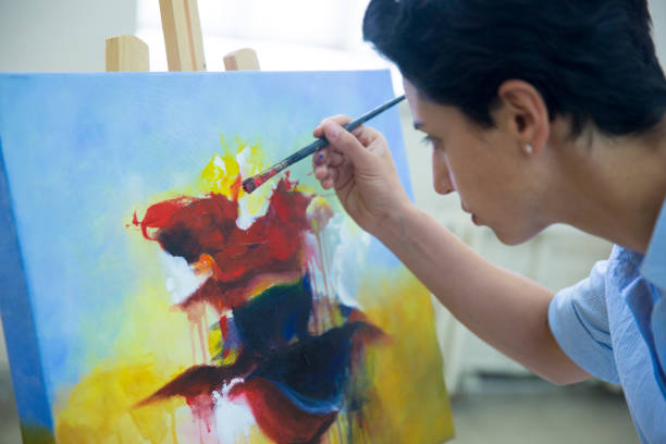 istock Fine art students working on painting 901813972