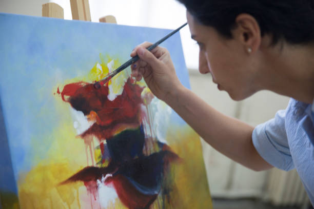 Fine art students working on painting in the classroom