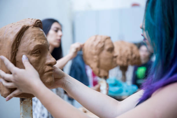 istock Artist working on clay sculpture in art studio 901814118