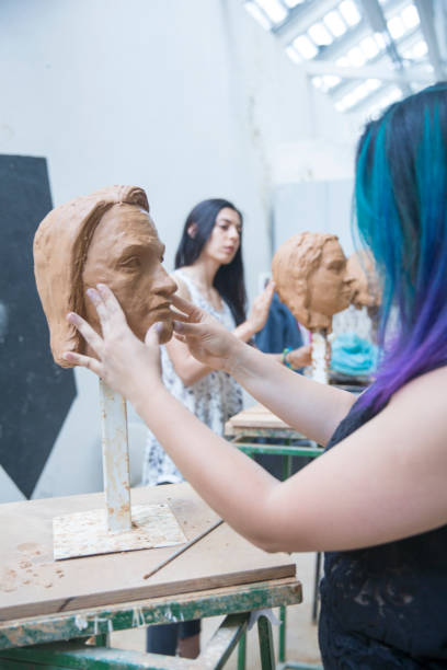 istock Artist working on clay sculpture in art studio 901814124