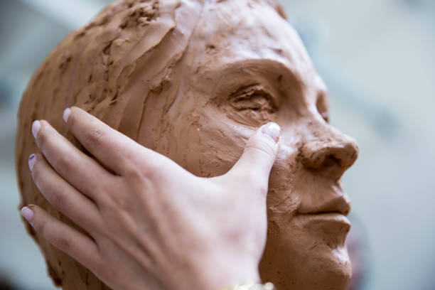 istock Artist working on clay sculpture in art studio 901814152