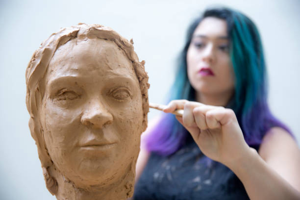 istock Artist working on clay sculpture in art studio 901814208