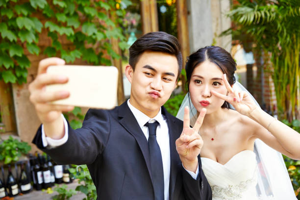istock asian newlywed taking a selfie 901816936