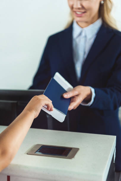 istock kid giving passport to staff 901817192