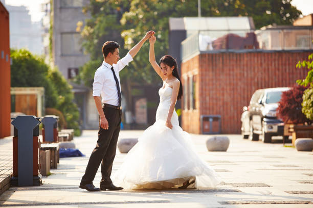 istock asian newlywed dancing outdoors 901817330