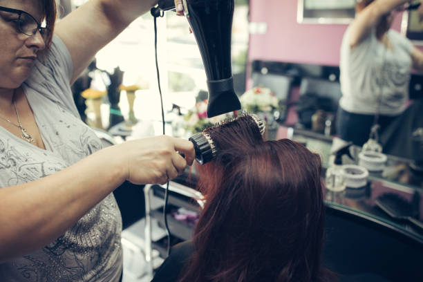 istock Professional hairdresser using hairdryer 901820996