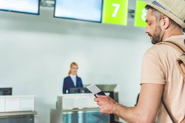 istock man with passport and ticket 901821532