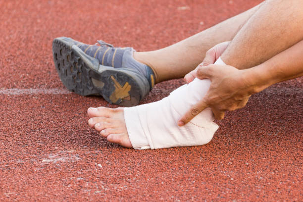 istock Male athlete applying compression bandage onto ankle 901822296