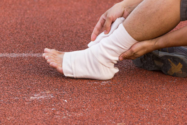 istock Male athlete applying compression bandage onto ankle 901822300